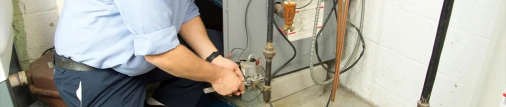 Total Comfort Cooling & Heating's Expert Working On A Gas Boiler