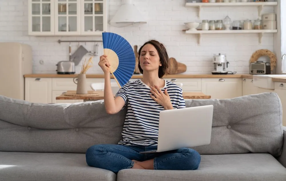 Woman On Couch With Hand Fan