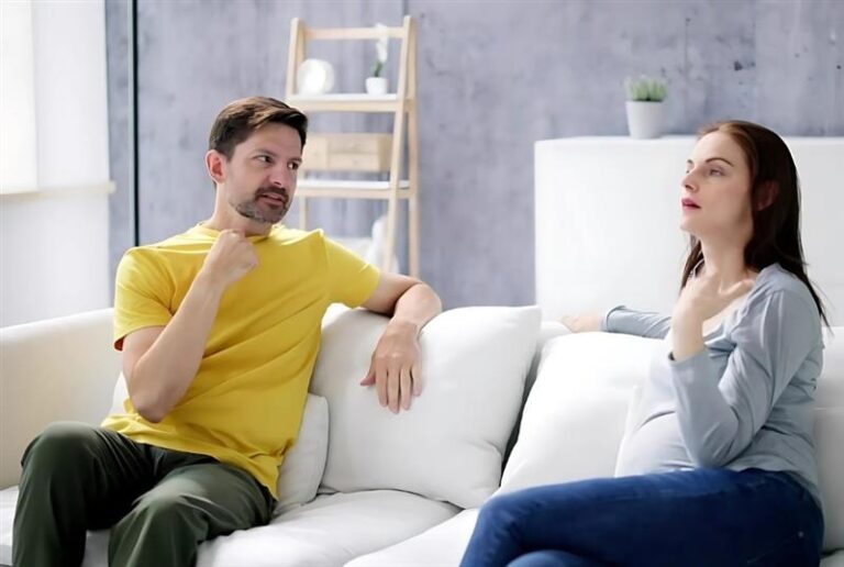 Couple Discussing at Home on the Couch
