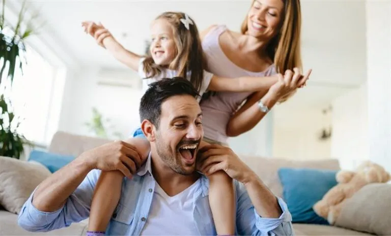 Happy Family Playing Together in Living Room with Air Conditioning