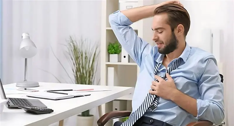 Man in Office Feeling Hot and Adjusting his Tie